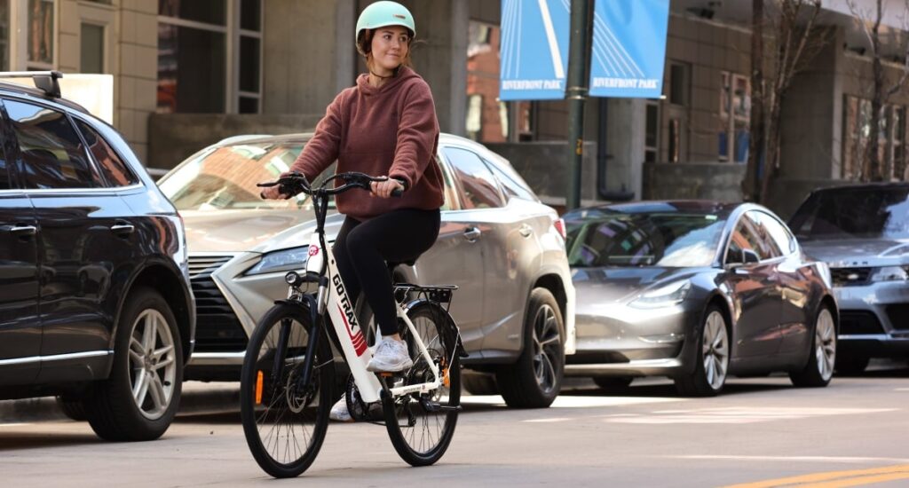 Photo of teen riding e-bike on street